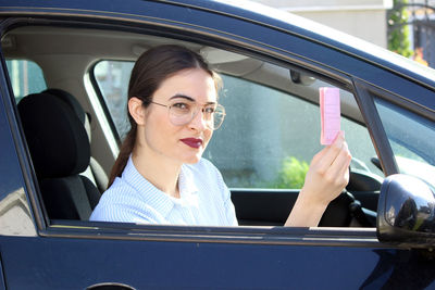 Portrait of woman sitting in car