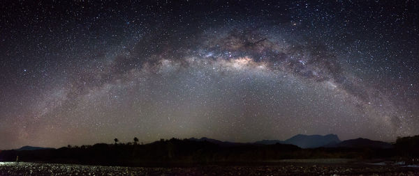 Scenic view of field against sky at night