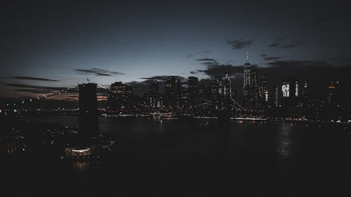 Illuminated cityscape against sky at night
