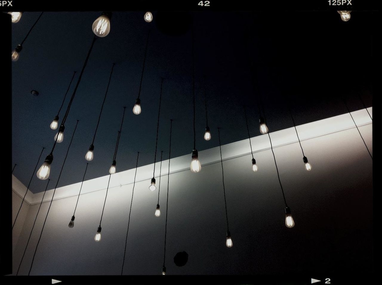 LOW ANGLE VIEW OF ILLUMINATED CEILING