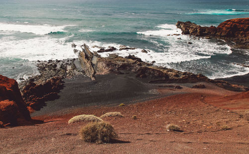 Scenic view of sea by rock formation