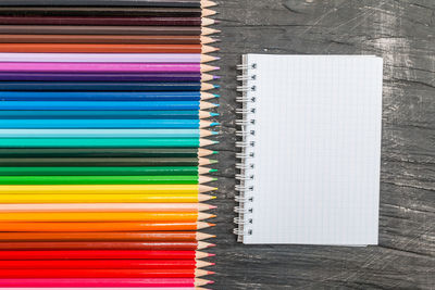 High angle view of multi colored pencils on shelf