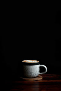 Coffee cup against black background