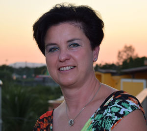 Portrait of smiling young woman against sky during sunset