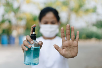 Close-up of man holding bottle