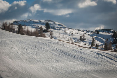 Snow covered land against sky