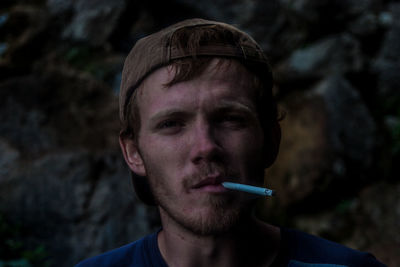 Close-up of man smoking outdoors