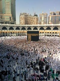 Crowd in city against clear sky