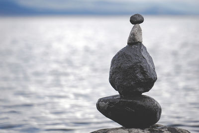 Close-up of statue against sea