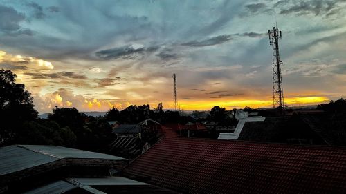 Houses against sky during sunset