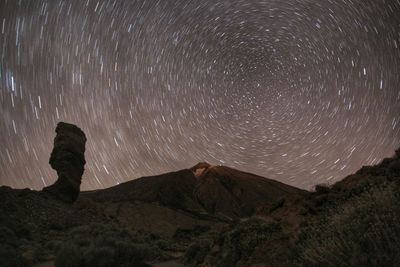 Scenic view of landscape against sky at night