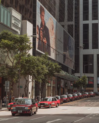 Cars on street by buildings in city