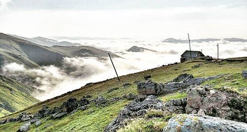 Scenic view of landscape against cloudy sky