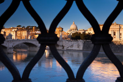 Bridge over river with buildings in background