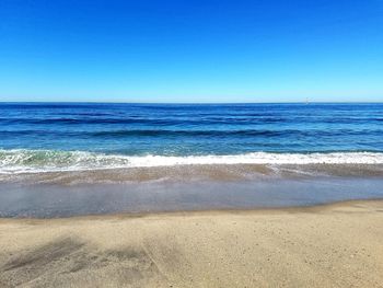 Scenic view of sea against clear blue sky