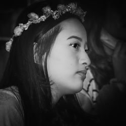 Close-up portrait of young woman looking away