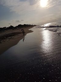 Scenic view of beach against sky during sunset