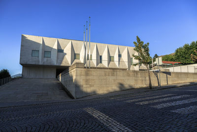 Low angle view of building against clear blue sky