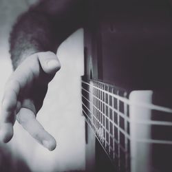 Close-up of hand playing guitar