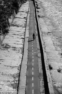 High angle view of man riding bicycle on road