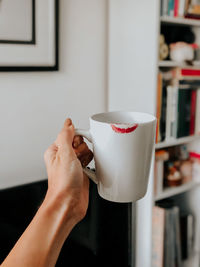 Midsection of woman holding coffee cup