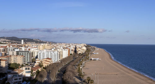 Aerial view of sea and buildings against sky