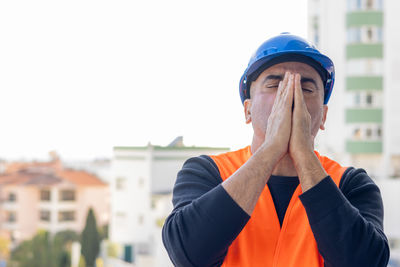 Side view of boy looking away against clear sky