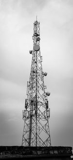 Low angle view of communications tower against sky