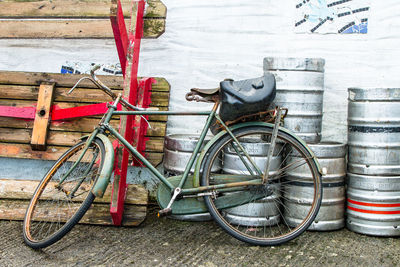 Bicycle parked and containers on footpath