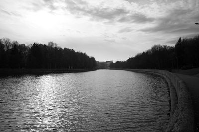 Scenic view of river against cloudy sky