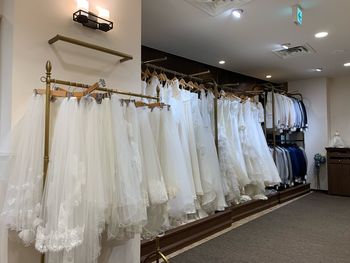 Wedding dresses hanging in shop for sale