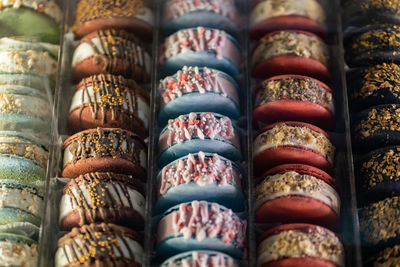 Closeup of colorful french macaron in showcase. top view.