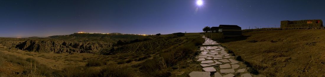 Panoramic view of landscape against clear sky at night