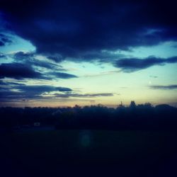 Silhouette of landscape against cloudy sky