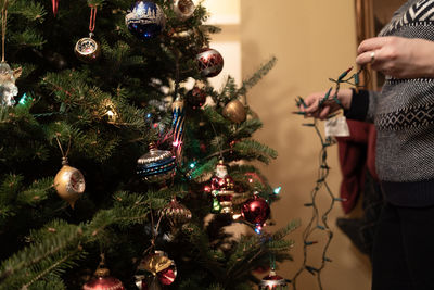 Midsection of christmas tree at home