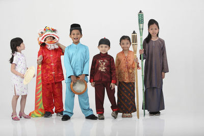 Children in various clothing against white background