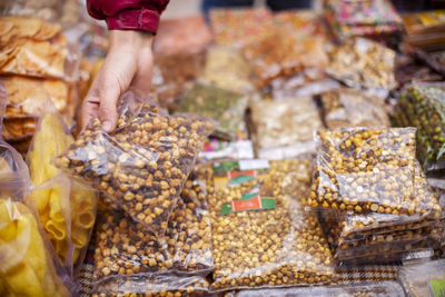 Midsection of man for sale at market stall