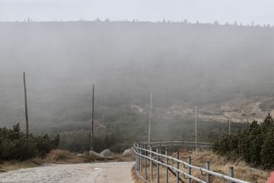 Scenic view of mountains against sky during foggy weather