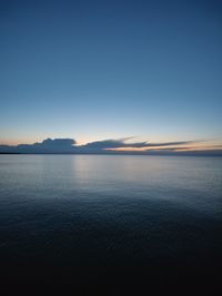 Scenic view of sea against clear sky during sunset