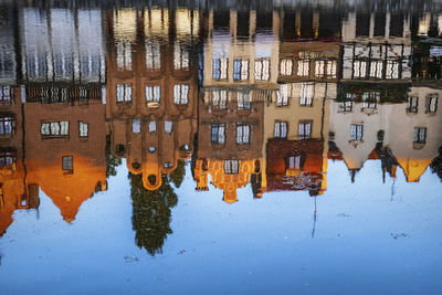 Reflection of buildings in motlawa river at sunrise