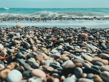 Rocks on beach against sky