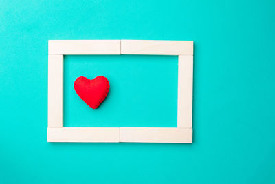 Directly above shot of heart shape on blue background
