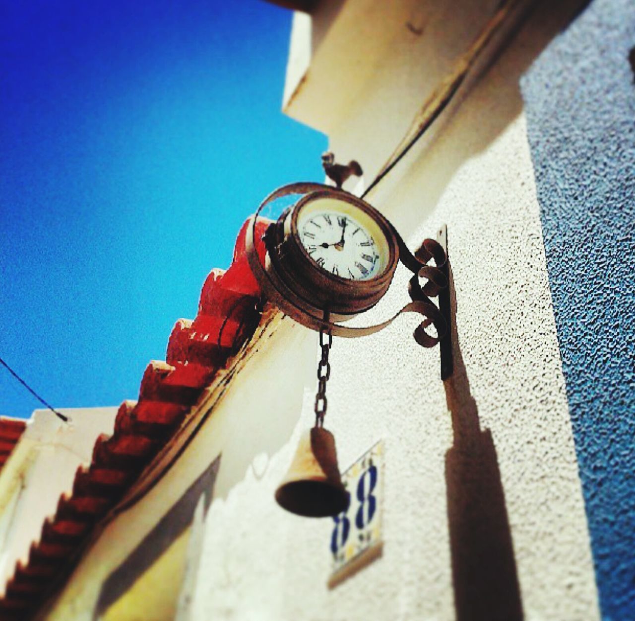 retro styled, low angle view, old-fashioned, technology, clock, time, close-up, transportation, metal, day, number, clear sky, wood - material, part of, outdoors, antique, no people, sunlight, accuracy, mode of transport