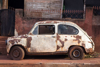 Old rusty car in city