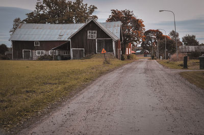 Road amidst buildings against sky