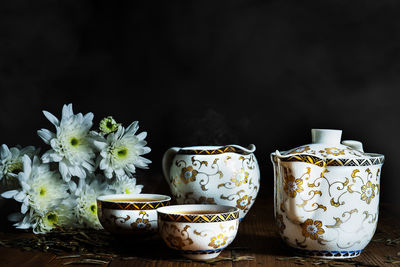 Close-up of potted plant on table against black background