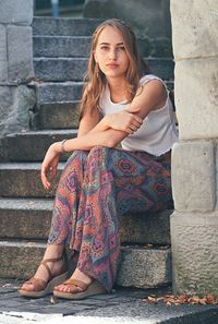 Portrait young woman sitting on staircase