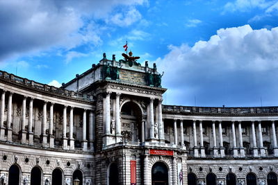 Low angle view of hofburg palace against cloudy sky
