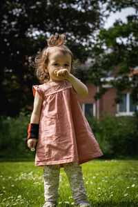 Portrait of girl standing on field