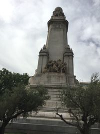 Low angle view of statue against cloudy sky